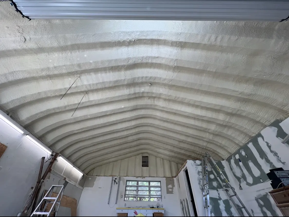 Spray polyurethane foam applied to the underside of a metal roof deck in Essex